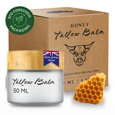 Honey Tallow Balm jar with packaging and honeycomb on a white background